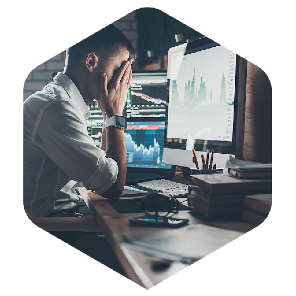 frustrated man in front of a computer looking at data