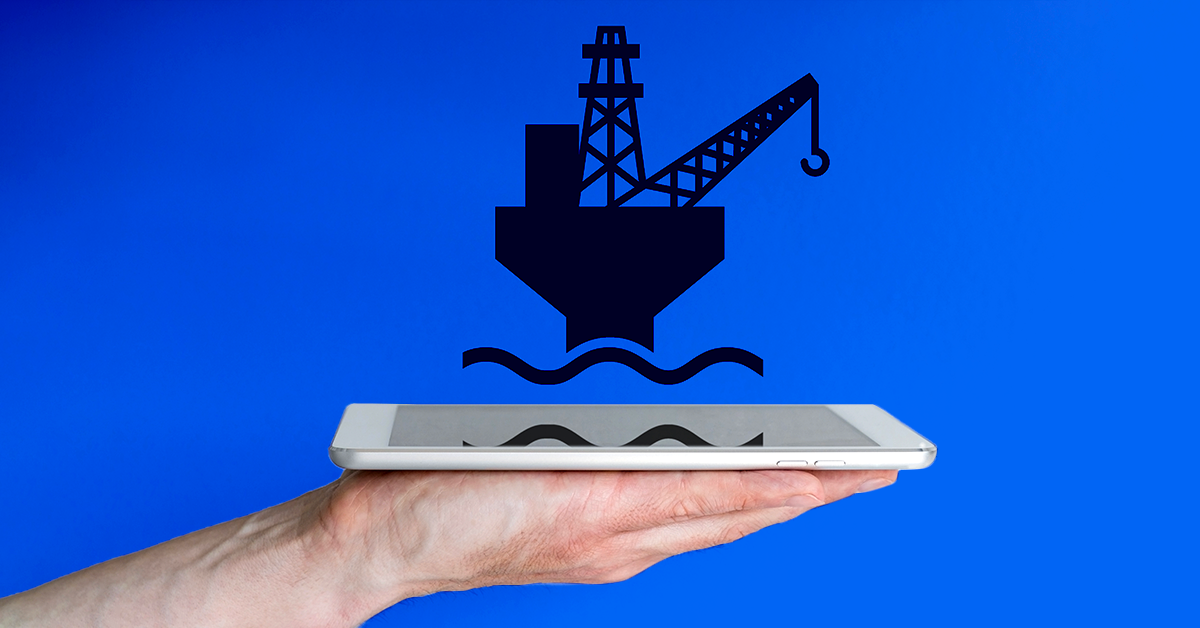 hand holding ipad with oil rig over the top