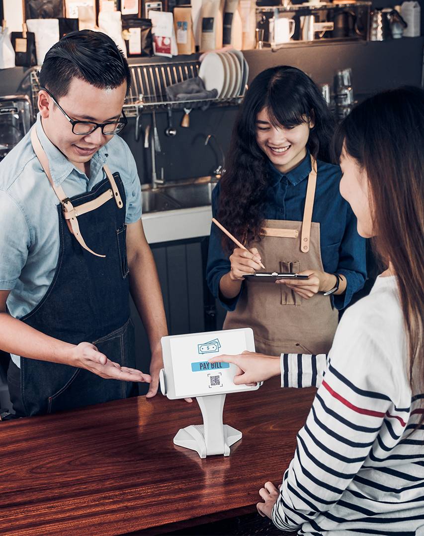 customer checking out at coffee shop using point of sale system